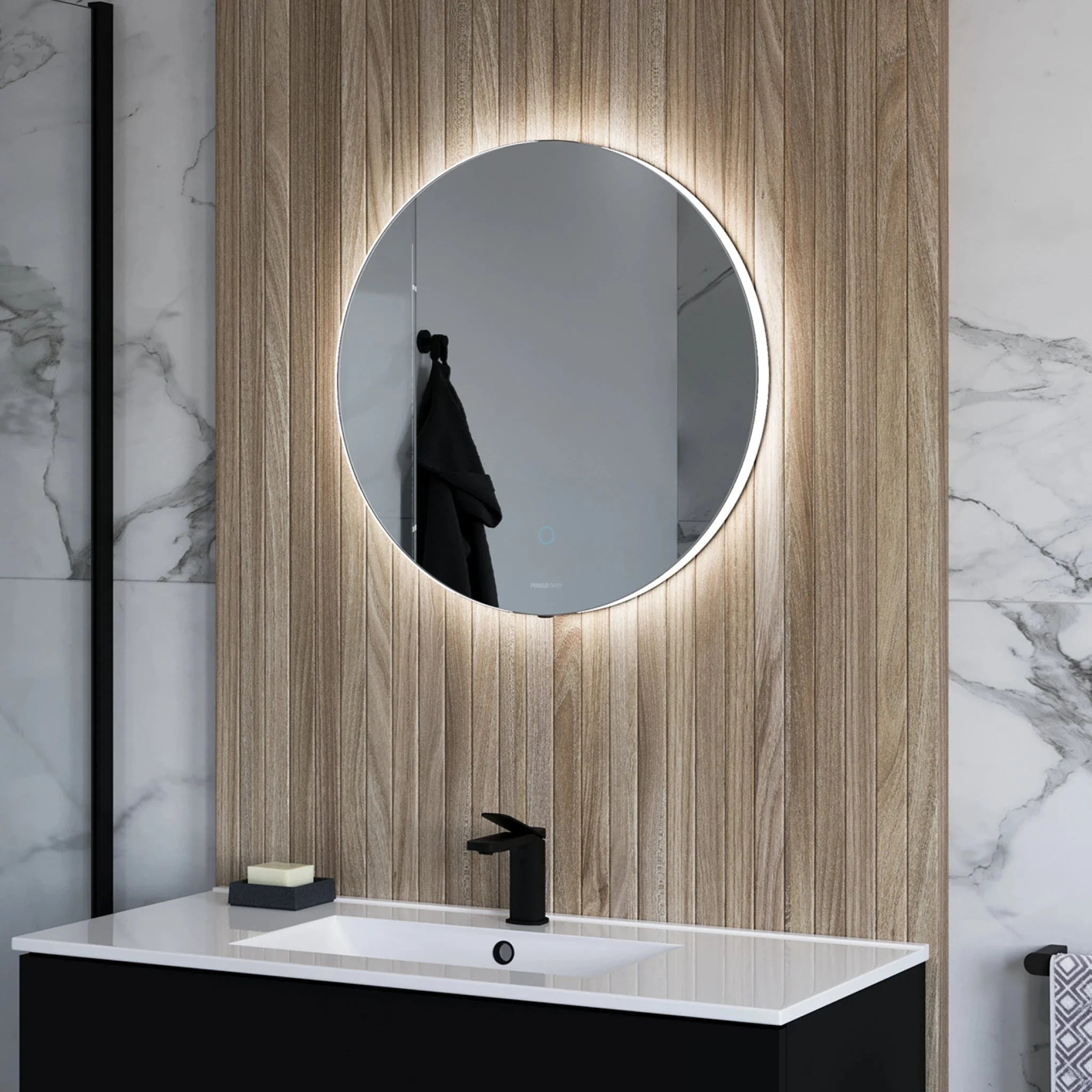 Halo round backlit LED bathroom mirror fitted above a basin